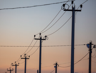 Electric pole on the background of the sunset. Technology