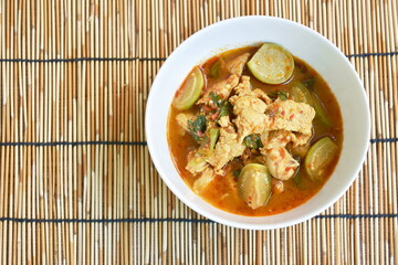 spicy boiled chicken with eggplant in curry soup on bowl