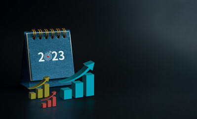 Happy new year 2023 background. 2023 numbers year with goal target icon on blue small desk calendar...