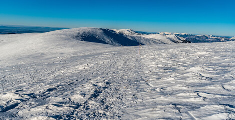 Western part of Low Tatras and Velka Fatra mountains from hiking trail above sedlo Durkovej in Slovakia during winter