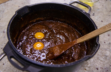 Egg yolks and applesauce in a saucepan. Mass for making homemade marshmallows.