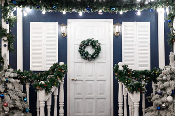 House decorated with garlands in the New Year's style. Beautiful Christmas background from bokeh.
