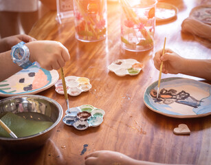 Little girls at painting master class in workshop space