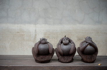 Three monkey ,close up of hand small statues with the concept of see no evil, hear no evil and...