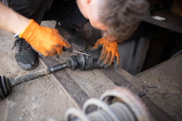 Repair and replacement of the axle shaft and CV joint with an anther of an automobile drive.