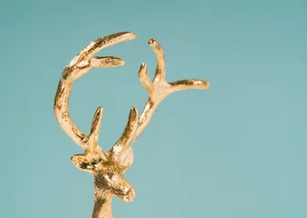 Foto auf Acrylglas Christmas deer golden ornament macro. Winter holidays minimal background. © Neeqolah