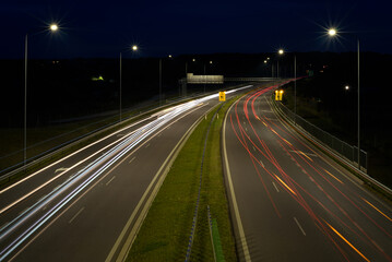 ON THE ROAD AT NIGHT - Car traffic on a modern expressway
