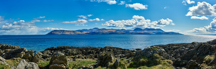 Fototapeta na wymiar View east from the B8001 by Skipness, from north to south, a panoramic view of the Isle of Arran across the Kilbrannan Sound. Tarbert, Argyll and Bute. Scotland