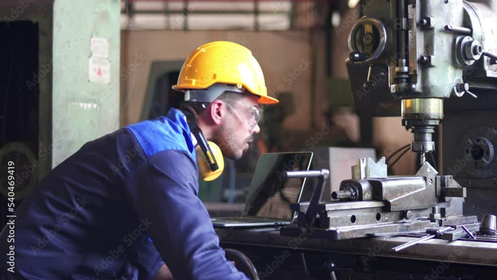 Wall mural Professional maintenance engineer, technician worker, repairman wear uniform, safety hard hat using laptop computer checking control machine in factory. Manufacturing heavy machine Industry concept.