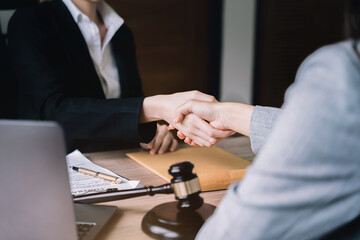 Business people and lawyers shaking hands after discussing a contract agreement done.