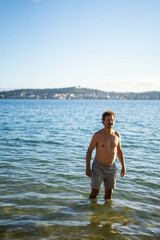 Caucasian happy man in the beach with a swimsuit