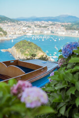 small amusement park boat in front of a landscape in San Sebatian