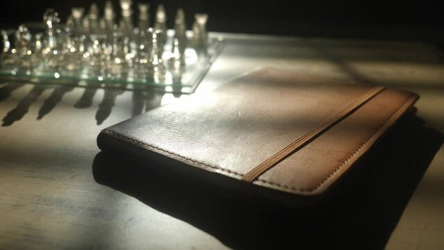 Leather journal on table evening window light