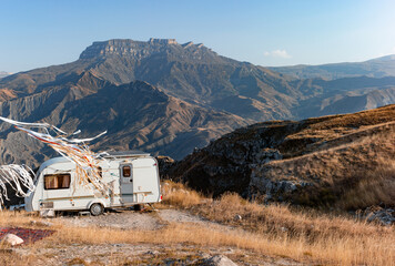 Camper decorated with ribbons against the backdrop of autumn mountains. Near the village of Golotl in the Khunzakh region of the Republic of Dagestan.