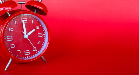 Red alarm clock on red background,with copy space