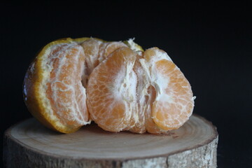 peeled oranges on black background