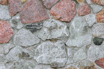 Background, texture of a wall made of old stones, cobblestones. Photography of nature.