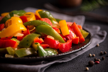 Cooked bell peppers of different colors, healthy vegetable dish