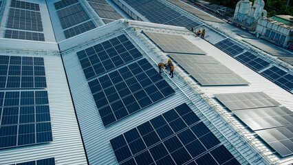 Fly over unidentified Engineering set up a Solar cell on the roof of a large industrial factory. Solar roofs are generating renewable energy for the industry.