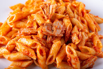 Pasta with tuna in tomato sauce, typical food of Mediterranean Italian cuisine.