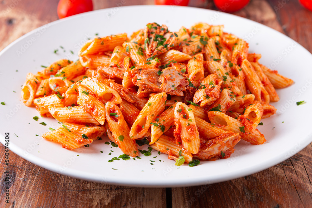 Poster Pasta with tuna in tomato sauce, typical food of Mediterranean Italian cuisine.