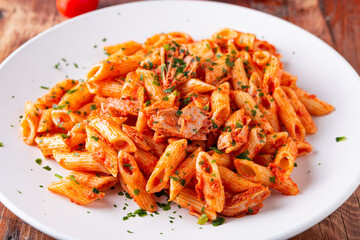 Pasta with tuna in tomato sauce, typical food of Mediterranean Italian cuisine.