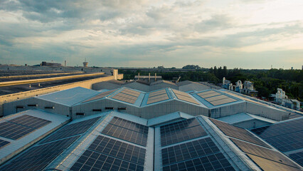 Footage over Solar cell on the roof of a large industrial factory. Solar roofs are generating...