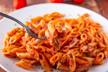 Pasta with tuna in tomato sauce, typical food of Mediterranean Italian cuisine.