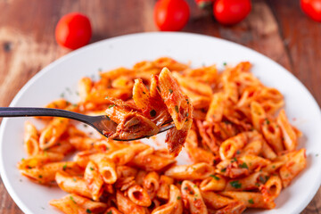 Pasta with tuna in tomato sauce, typical food of Mediterranean Italian cuisine.