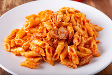 Pasta with tuna in tomato sauce, typical food of Mediterranean Italian cuisine.