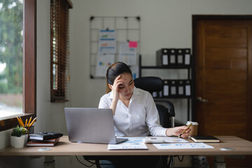 Tired asian business woman with headache at office, feeling sick at work