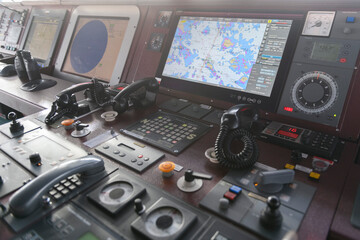 Navigational control panel and VHF radio. Working on the ship's navigational bridge. Blurred image.