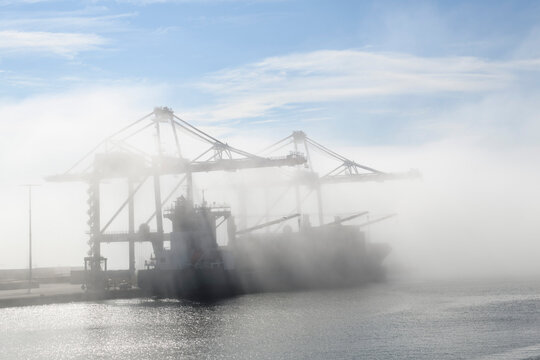 Container ship in port, strong fog. Foggy weather. Bad visibility.