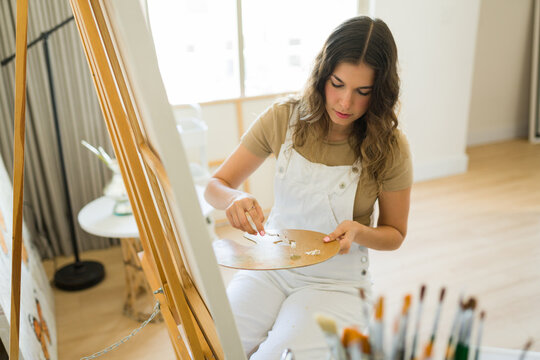 Talented artist painter feeling inspired painting