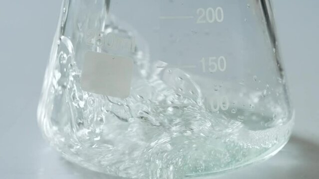 Liquid poured into lab equipment in slow motion