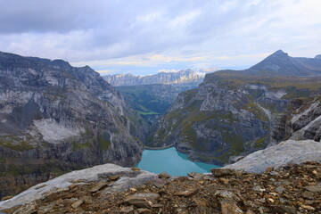 Limmerensee reservoir surrounded by Muttenchopf mountain and Muttsee mountain lake in Glarus, Switzerland