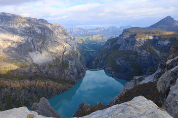 Limmerensee reservoir surrounded by Muttenchopf mountain and Muttsee mountain lake in Glarus,...