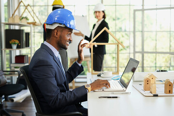 portrait attractive african american engineer chatting by laptop while meeting in the office