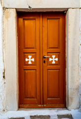 Brown wooden door on a Greek Orthodox chapel on Paros island
