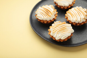 Appetizing lemon cupcakes with white cream on beige background. Holiday, surprise, birthday, Valentine's Day.