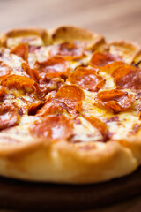 Pepperoni pizza in close, vertical frame, texture of ingredient