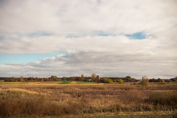 Fototapeta premium autumn landscape with a village in the distance
