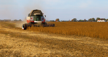 Combine Harvester Working in a Field on a Farm. Seasonal Harvesting the Wheat. Agriculture. Crop....