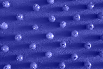 Tomatoes cherry, scattered in a chaotic manner on a Purple Background. Food background, design. Trendy Image, Toned in Color of the year 2022, Very Peri.