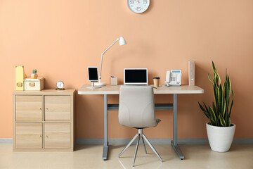 Interior of room with standing desk near color wall