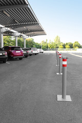 Limiters with red and white stripes on parking under canopy