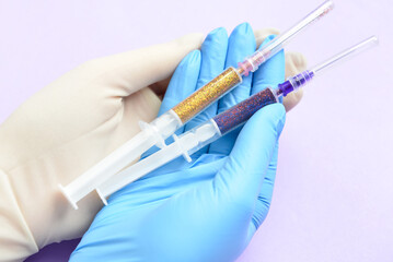 Woman in different medical gloves holding syringes on color background, closeup