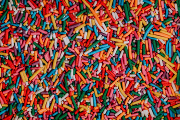 Sugar sprinkle dots background. Colorful decoration for cake