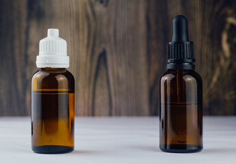 different cbd oil or organic cosmetics brown glass bottle with pipette.