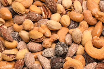  A group of almonds, pistachios, walnuts, macadamia, cashews.